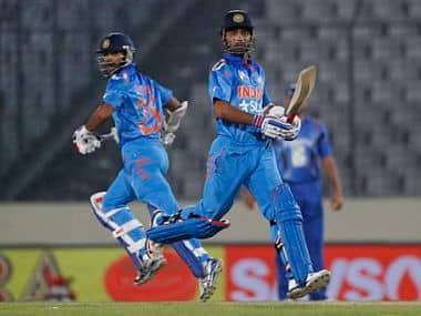 India's Ajinkya Rahane, right, and Shikhar Dhawan run between the wickets during their match against Afghanistan. AP