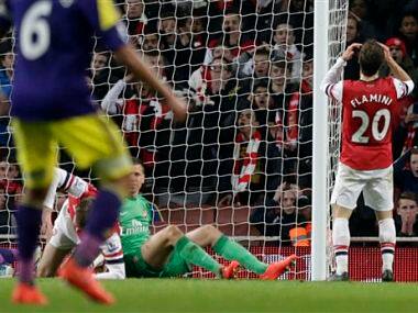 Arsenal's Mathieu Flamini, right, reacts in frustration after scoring an own goal to make the final score 2-2 during the English Premier League soccer match between Arsenal and Swansea City at the Emirates Stadium. AP