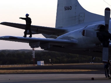 An aircrew walks on the wing of a Japanese Air Force AP-3C Orion after it landed at RAAF Pearce Base before it joins the search for missing Malaysian Airlines flight MH370 in Perth. Reuters