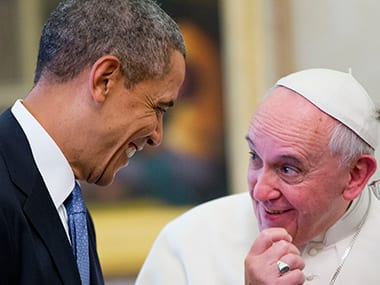 US President Barack Obama and Pope Francis share a light moment at the Vatican. AP