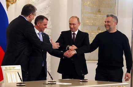 Russian President Vladimir Putin, second right, Speaker of Crimean legislature Vladimir Konstantinov, second left, Crimean Premier Sergei Aksyonov, left, and Sevastopol mayor Alexei Chalyi, right, shake hands after signing a treaty for Crimea to join Russia in the Kremlin in Moscow. AP