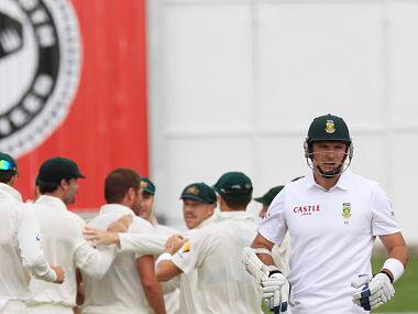 South Africa's captain Graeme Smith, right, walks back to the players pavilion after dismissed. AP
