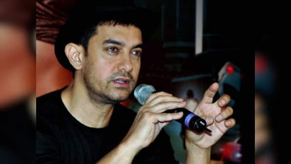 Is Aamir Khan forcing his society members to sell their flats?  