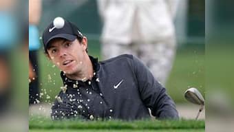 McIlroy soars, and Woods nearly misses the cut 