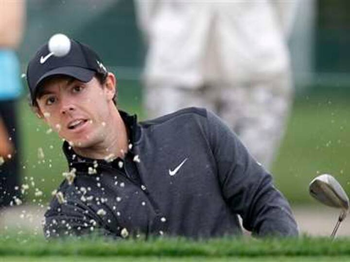 McIlroy soars, and Woods nearly misses the cut 