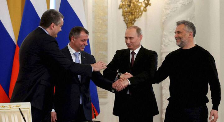 Deal sealed: Putin's expression sums up how Russia feels about Crimea's accession Deal sealed: Putin's expression sums up how Russia feels about Crimea's accession