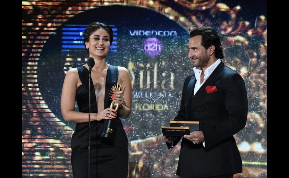 Bollywood actress Kareena Kapoor and Bollywood actor Saif Ali Khan present the award for Best Playback Male Singer on stage at the Raymond James Stadium on the fourth and final day of the 15th International Indian Film Academy (IIFA) Awards in Tampa, Florida, April 26, 2014. AFP PHOTO JEWEL SAMAD
