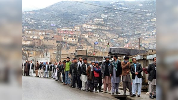 Millions of Afghans defy Taliban to vote in historic election