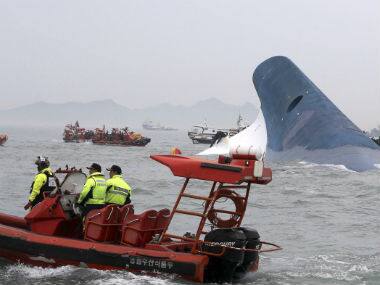 South Korean coast guard officers and rescue team members try to rescue passengers from the ferry Sewol in the water off the southern coast near Jindo, south of Seoul. AP 