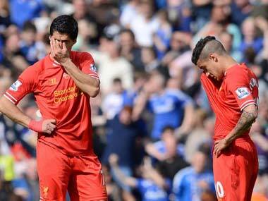 Luis Suarez and Philippe Coutinho are crestfallen after the Chelsea loss. AFP