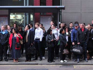 Commuters queue for buses outside Waterloo Station in London. AFP.