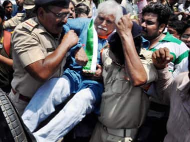 Madhusdhan Mistry being detained for vandalising Modi's posters. PTI
