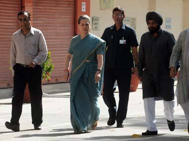Ajay Maken and Sonia Gandhi on their way to cast their votes. AFP