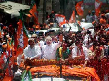  BJP Prime Ministerial candidate Narendra Modi waves at supporters during a road show before filing his nomination papers in Varanasi on Thursday. PTI 