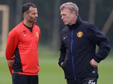 File photo of David Moyes with Ryan Giggs, the man who has replaced him. AFP