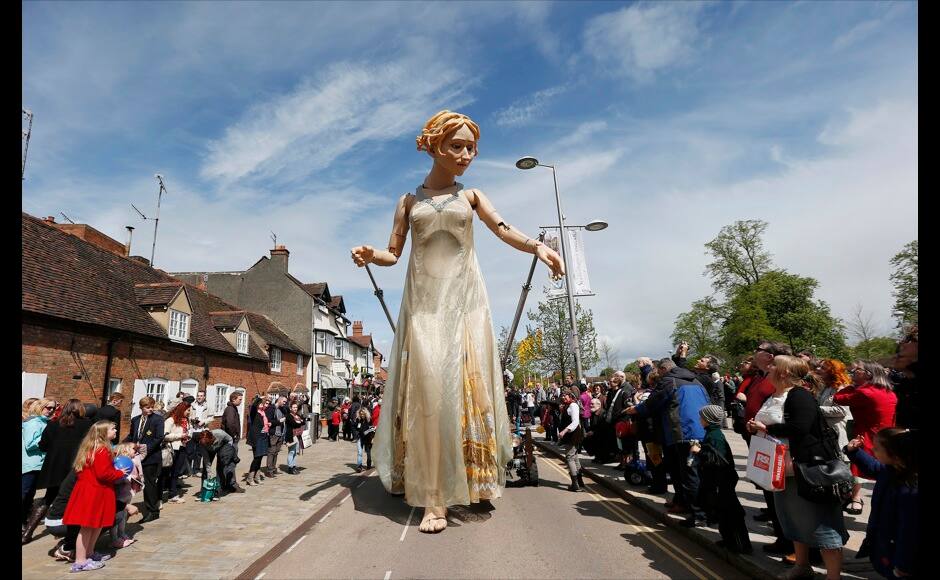 A giant Lady Godiva puppet joins a procession outside the Royal Shakespeare Theatre marking the 450th anniversary of William Shakespeare's birth in Stratford-upon-Avon, southern England April 26, 2014. Shakespeare's birthplace of Stratford-upon-Avon is hosting a weekend of festivities in celebration of their famous son who was regarded as England's greatest playwright. REUTERS/Suzanne Plunkett 