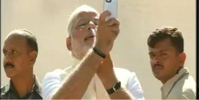 Modi's voter selfie #fail: Sticks BJP lotus up his nose Modi's voter selfie #fail: Sticks BJP lotus up his nose