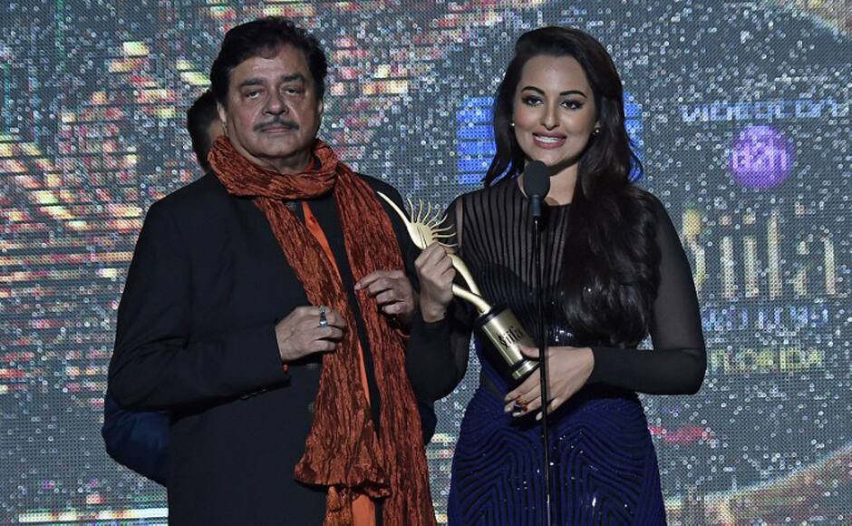 Sonakshi Sinha beams with pride as she presents the Lifetime Achievement Award to her father and actor-politician Shatrughan Sinha. AFP. 