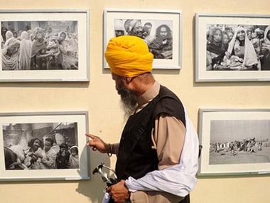 File image of a Sikh man looking at photos of the 1984 riots. AFP
