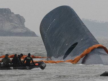 South Korean Coast Guard officers search for missing passengers aboard a sunken ferry in the waters off the southern coast near Jindo, South Korea. AP
