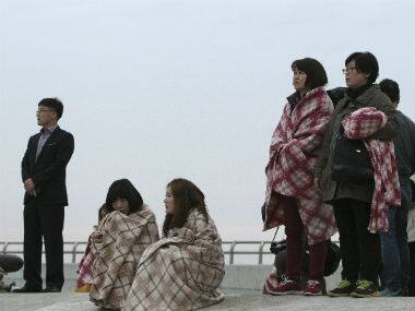 Relatives wait for their missing loved ones at a port in Jindo, South Korea. AP 