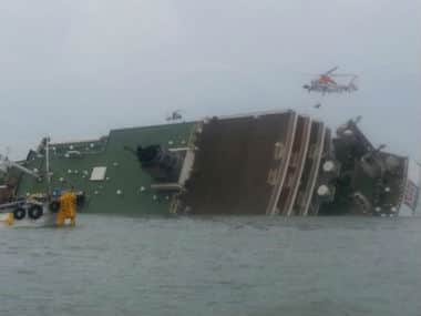 South Korea rescue helicopter and fishing boats try to rescue passengers from a passenger ship in water off the southern coast in South Korea. AP