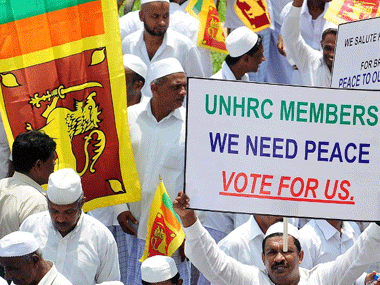 File photo of protesters holding placards and Sri Lankan flags as they shout slogans against the UNHRC resolution in Colombo. AFP