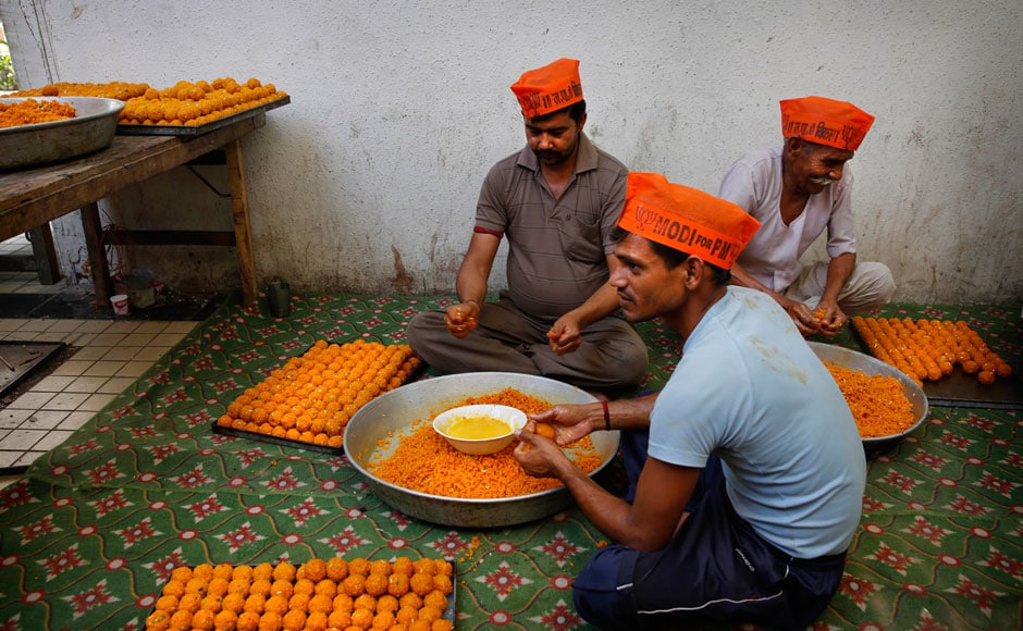 At the BJP office, the celebrations have already begun. Here BJP party workers are seen making sweets wearing the Modi for PM cap. Reuters At the BJP office, the celebrations have already begun. Here BJP party workers are seen making sweets wearing the Modi for PM cap. Reuters