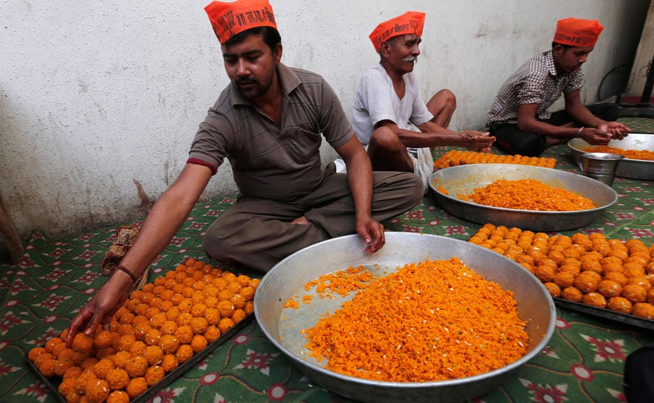 Workers bind the ladoos together ahead of BJP's celebrations. AP Workers bind the ladoos together ahead of BJP's celebrations. AP