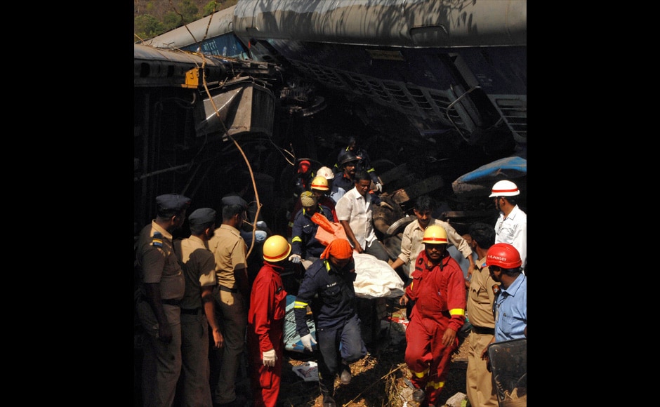 Rescuers remove the body of a passenger from the debris. Reuters Rescuers remove the body of a passenger from the debris. Reuters