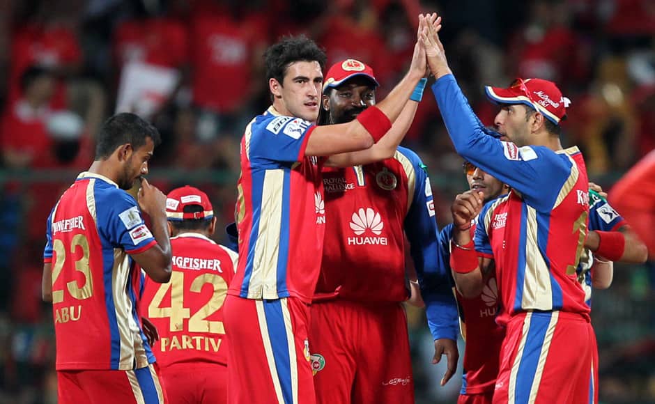 Mitchell Starc and Yuvraj Singh of the Royal Challengers Banglore celebrates wicket of Quinton de Kock of Delhi Daredevils during match 38 of the Pepsi Indian Premier League Season 2014 between the Royal Challengers Bangalore and the Delhi Daredevils held at the M. Chinnaswamy Stadium, Bangalore, India on the 13th May 2014Photo by Prashant Bhoot / IPL / SPORTZPICS