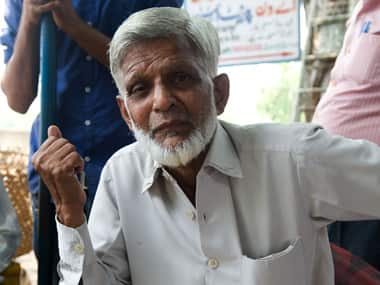 Modi greets the crowd with a victory symbol outside the New Delhi airport. AP Photo