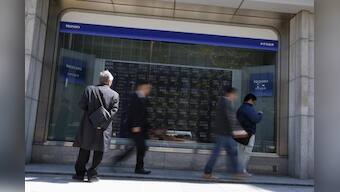 Asian shares wobble in early trade, dollar slips