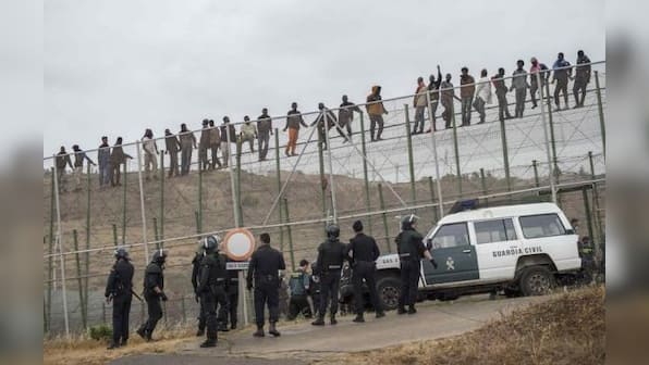 Hundreds of migrants storm across Spanish border at Melilla