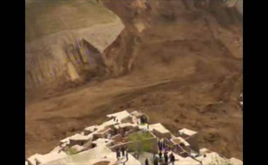 This image made from AP video shows people searching for survivors after a massive landslide landslide buried a village Friday, May 2, 2014 in Badakhshan province, northeastern Afghanistan, which Afghan and U.N. officials say left hundreds of dead and missing missing. (AP Photo via AP video)