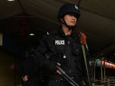 A Chinese policeman stands guard outside a railyway station in this file photo. AFP
