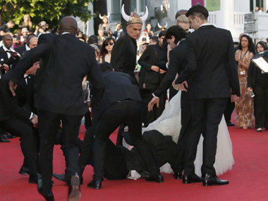 Cannes 2014: Man uses actress' dress as cover to hide from security Cannes 2014: Man uses actress' dress as cover to hide from security