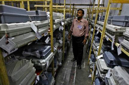 An official stands inside a strong room filled with electronic voting machines (EVM) before the start of the vote counting. Reuters