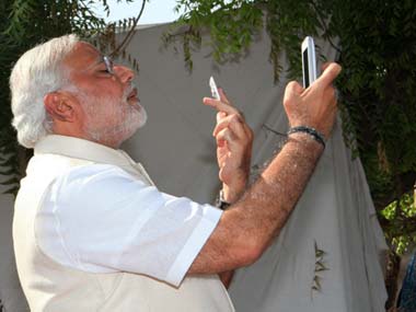 Narendra Modi took a selfie after he voted in Baroda. AFP