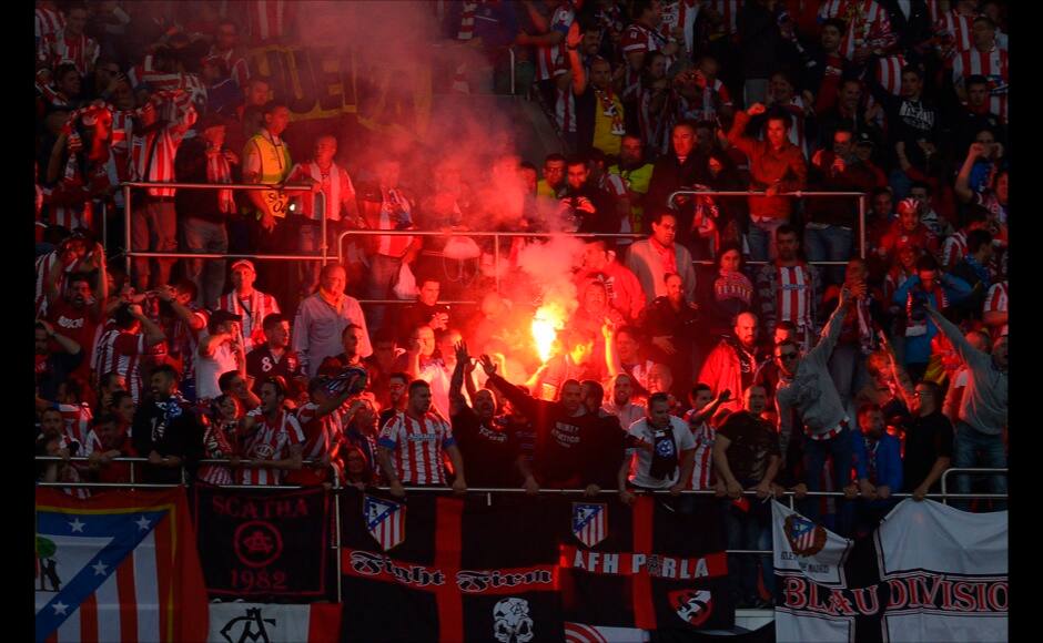 Atletico supporters release flares, during the Champions League final soccer match between Atletico Madrid and Real Madrid, at the Luz stadium, in Lisbon. AP