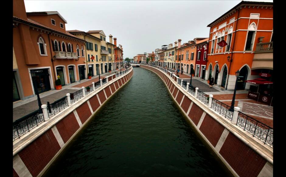 A canal flows through the center of the Florentia Village in the district of Wuqing, located on the outskirts of the city of Tianjin June 13, 2012. The shopping center, which covers an area of some 200,000 square meters, was constructed on a former corn field at an estimated cost of US$220 million and copies old Italian-style architecture with Florentine arcades, a grand canal, bridges, and a building that resembles a Roman Coliseum. REUTERS