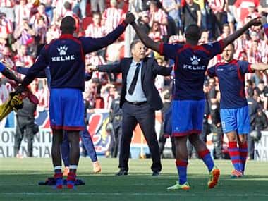 Levante's coach Joaquin Caparros and his players celebrate their victory against Atletico de Madrid. AP