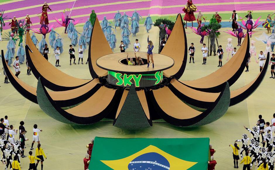 Brazilian singer Claudia Leitte, right, US singer Jennifer Lopez and rapper Pitbull perform during the opening ceremony ahead of the group A World Cup soccer match between Brazil and Croatia, the opening game of the tournament, in the Itaquerao Stadium in Sao Paulo, Brazil, Thursday, June 12, 2014. (AP Photo/Shuji Kajiyama)