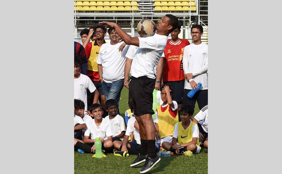 Brazilian football player Jose Ramirez Barretto along with children during a promotional event in Mumbai on Wednesday. PTI
