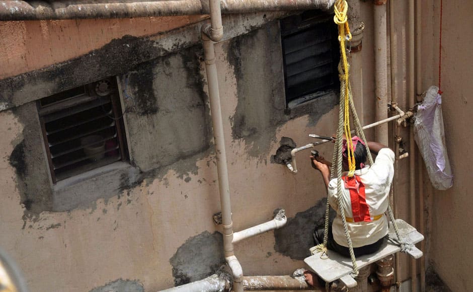 A BMC employee disconnects the water supply to the Campa Cola Society in Mumbai on Monday. PTI 