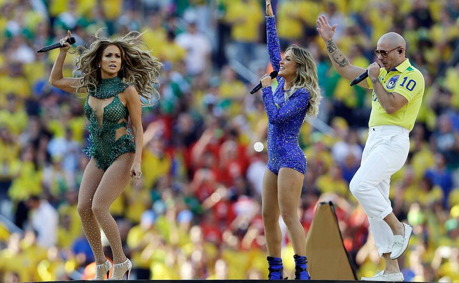 US singer Jennifer Lopez, left, rapper Pitbull and Brazilian singer Claudia Leitte perform during the opening ceremony ahead of the group A World Cup soccer match between Brazil and Croatia, the opening game of the tournament, in the Itaquerao Stadium in Sao Paulo, Brazil, Thursday, June 12, 2014. (AP Photo/Kirsty Wigglesworth)