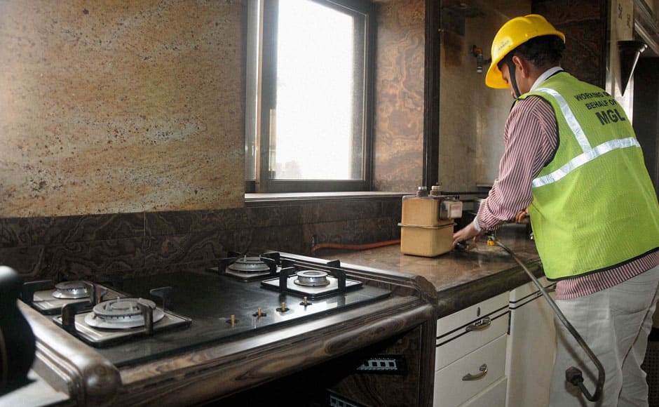 A BMC employee disconnects the gas supply to the Campa Cola Society in Mumbai on Monday. PTI