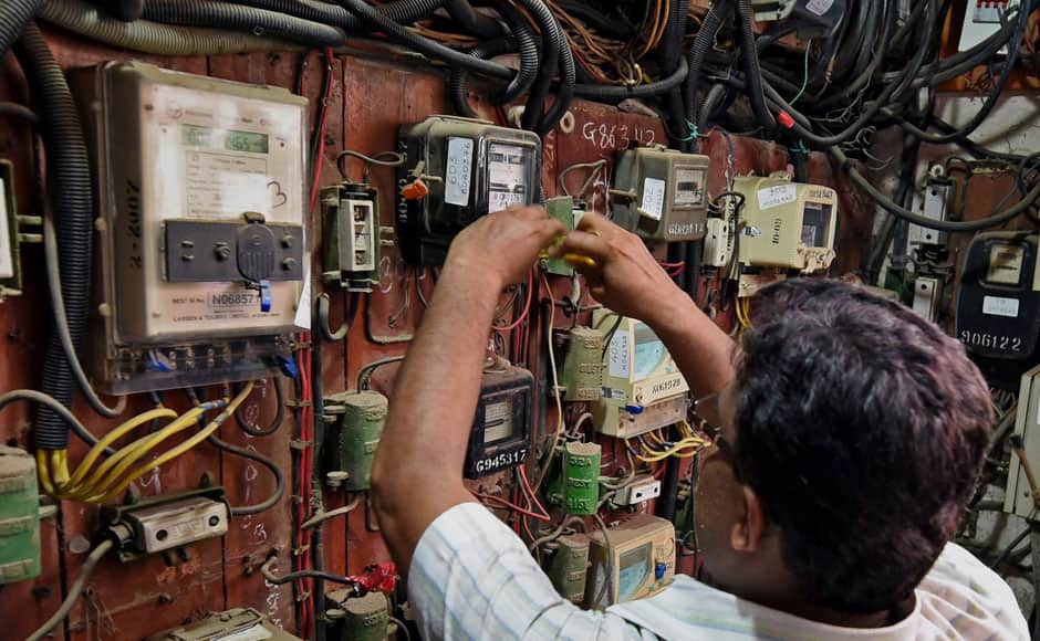 BMC officials disconnect the electric supply to the Campa Cola Society in Mumbai on Monday. PTI