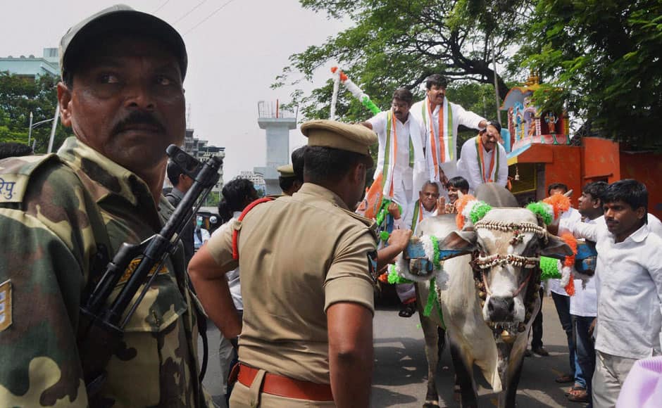 Congress MLA Vamshi Chand Reddy along with other members arrive by a bullock-cart to attend the first session of Telangana Assembly in Hyderabad on Monday to press for unconditional loan waiver to all farmers. PTI 