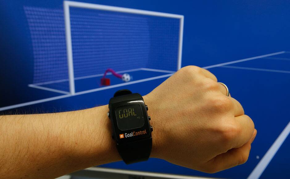 A GoalControl watch is displayed next to a control screen during a demonstration of the goal-line technology (GLT) in the western German city of Aachen May 28, 2014. German firm GoalControl has been appointed by FIFA as the official provider for the goal-line technology at the upcoming 2014 soccer World Cup in Brazil. GoalControl uses 14 high-speed cameras around the pitch as part of its GoalControl-4D system, which are fixed in elevated positions around each goalmouth. The ball's position is continuously captured in three dimensions - X, Y and Z coordinates. All the cameras are linked to a computer processing system, which filters out players, the referee and any other objects. Only the ball remains, with its position precise to a few millimetres in the coordinate system of the pitch, according to the GoalControl website. The watch will be worn by referees and will display the word 